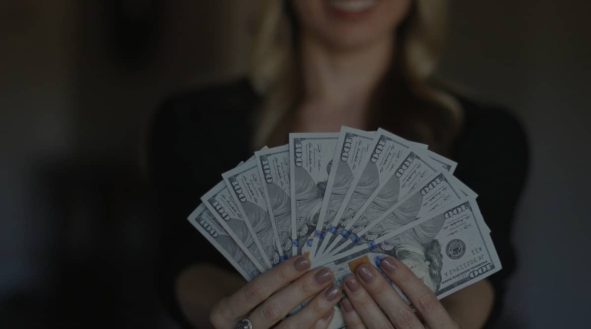 woman holding money fanned out