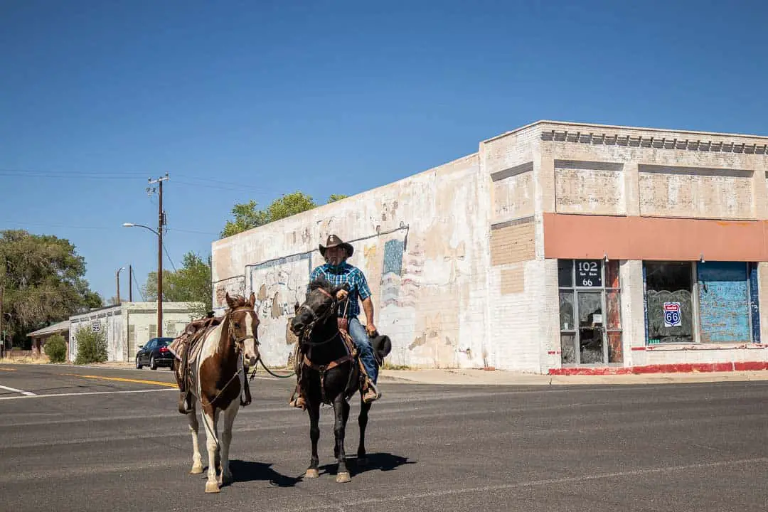 Cowboy with horses on the street in Seligman Arizona