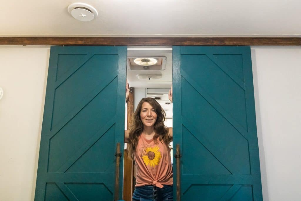 Fully decorated barn doors in RV bedroom remodel