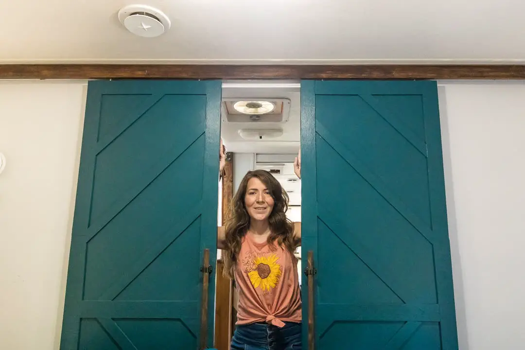 Sliding barn doors with a geometric pattern in a RV bedroom