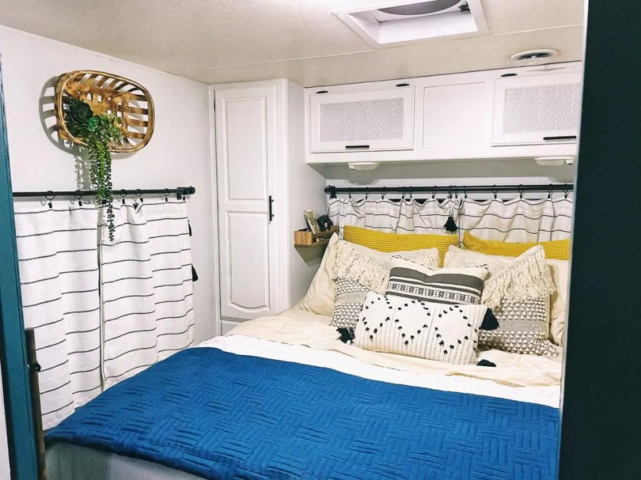 Bedroom in an RV with pretty throw pillows on bed
